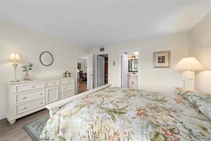 Another angle of the primary bedroom with walk-in closet and bathroom
