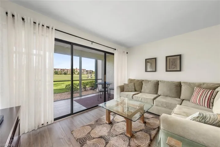 Bright interior space featuring a large sliding glass door with a screened lanai overlooking the golf course
