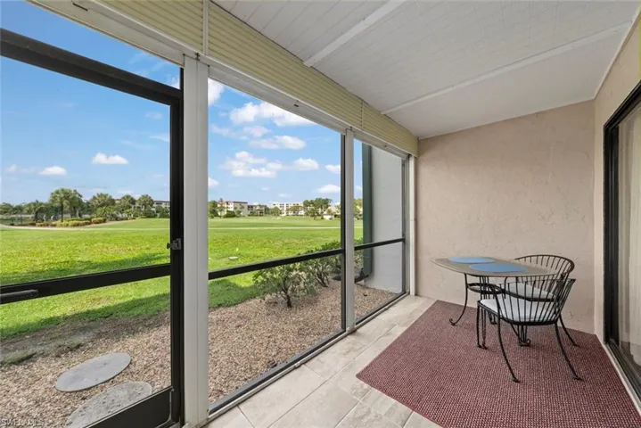 Screened lanai featuring tile flooring and the golf course