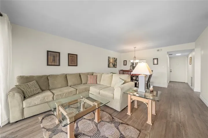 Open-concept living area featuring vinyl flooring and the dining space