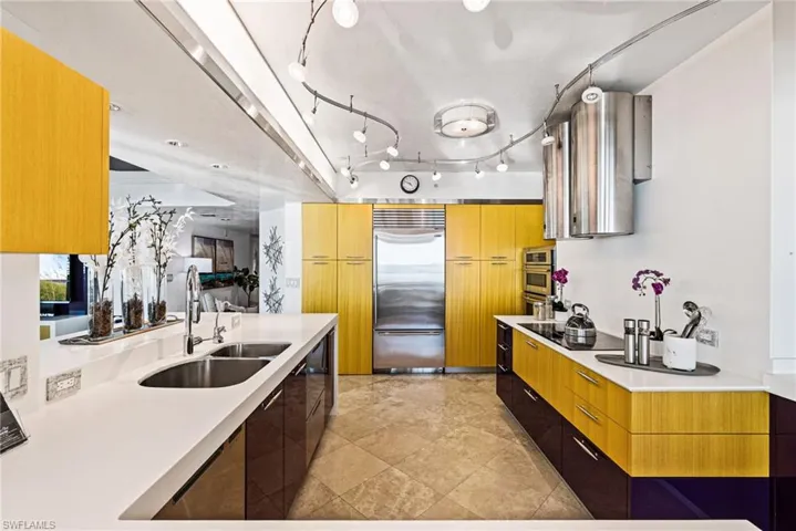 The chef's kitchen boasts dual Faber range hoods, Thermador cooktop, JennAir wall oven and microwave, Subzero refrigerator and dual-drawer dishwashers.