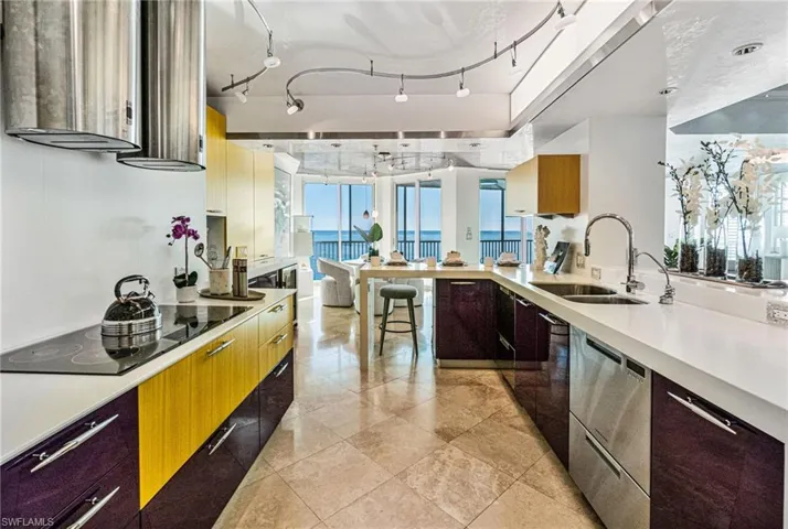 The chef's kitchen boasts dual Faber range hoods, Thermador cooktop, JennAir wall oven and microwave, Subzero refrigerator and dual-drawer dishwashers.