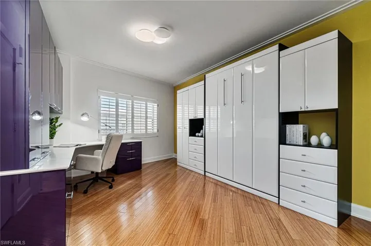 Bedroom #2 has been thoughtfully, customized and transformed into a multipurpose space with a built-in Murphy bed, storage and expansive office area all with Italian cabinetry to coordinate with the stunning custom kitchen.