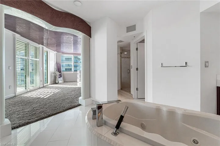 The primary ensuite bathroom has stunning views from the raised freestanding deck soaking tub.