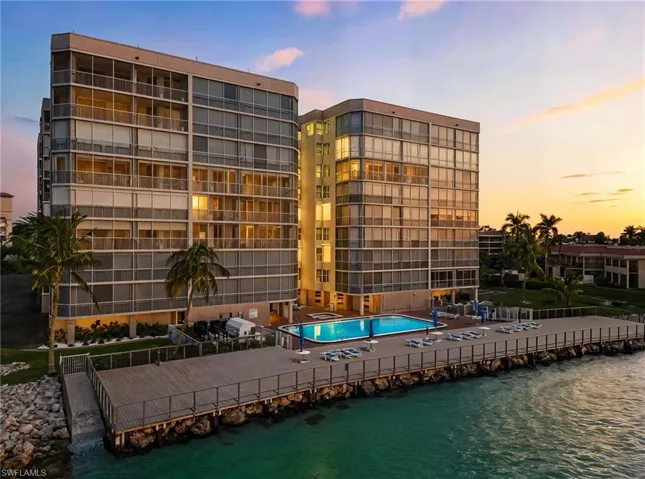 Twilight view of the prestigious Mirage - featuring the gulfside pool and boardwalk