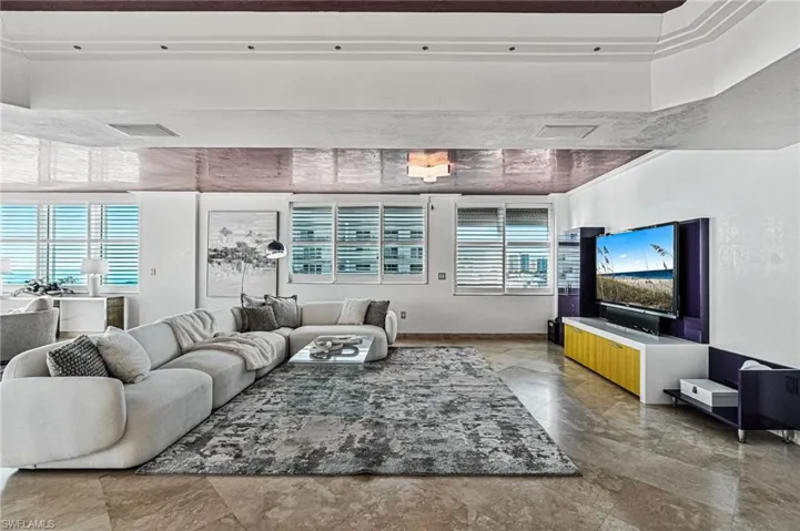 The expansive great room, with custom, built-in entertainment center is open to secondary seating, dining, and an Italian upgraded high-end chef kitchen.The great area features, custom, entertaining built-in to coordinate with the vibrant modern kitchen..