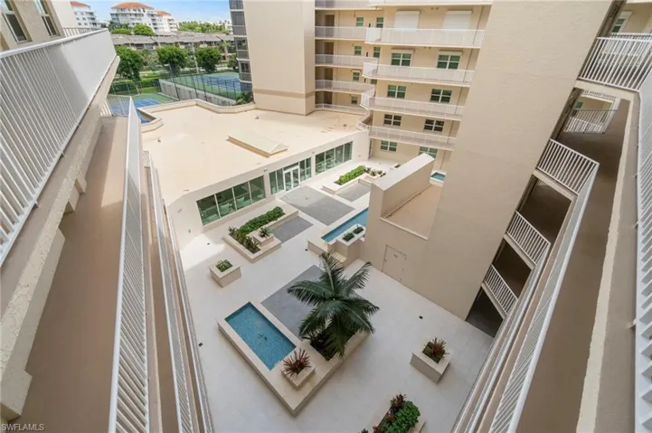 Looking down from the ninth-floor penthouse entry, you get a picturesque view of the complex—from the central water feature, seating areas, and gardens, all the way out to the tennis and pickleball courts. It’s a true bird’s-eye view.