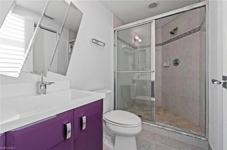 A full bath with a custom vanity and mirror is attached to the third bedroom.