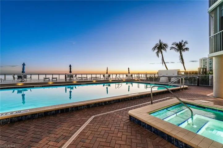 Community pool featuring a hot tub, stunning pool, spacious lounge patio area and private pier!