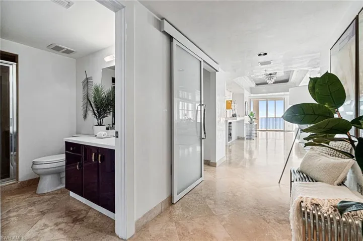 Bedroom #2 has an en-suite full bathroom with custom italian vibrant modern cabinetry to complement the built-ins throughout and doubles as a all-guest bathroom as it is situated off of the foyer entry with a secondary functional door.