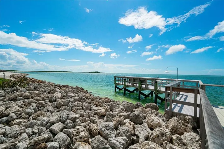 The GULF WATERS LEAD INTO A STUNNING SHORELINE complete with a Dock and fishing pier for breathtakingly beautiful views!