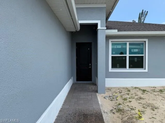 Property entrance featuring stucco siding