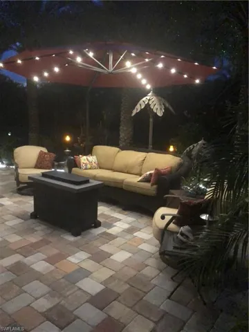 Patio at night featuring outdoor lounge area