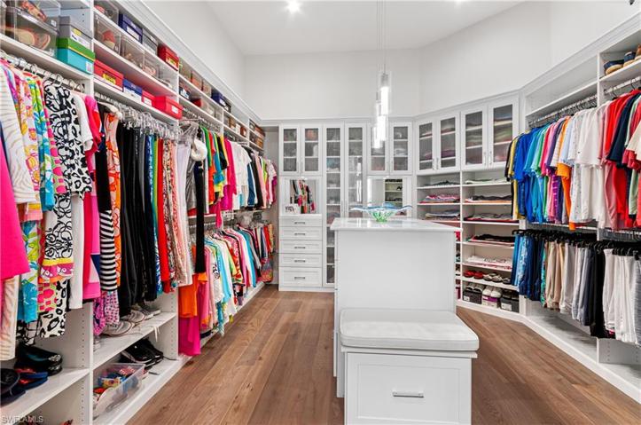 Master Closet with wood flooring