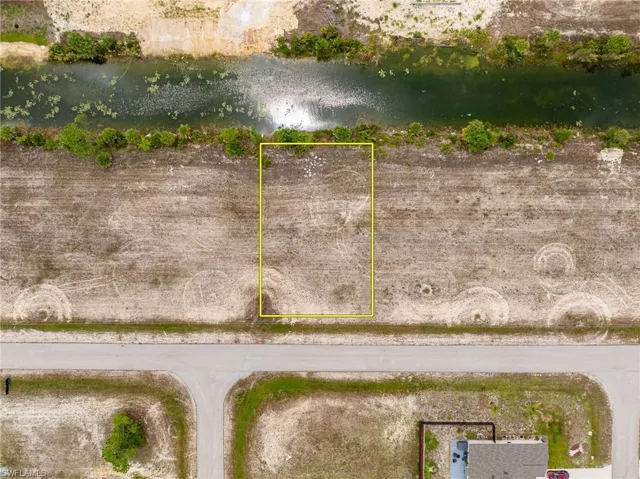Aerial overview of property's location featuring property parcel outlined and a nearby body of water