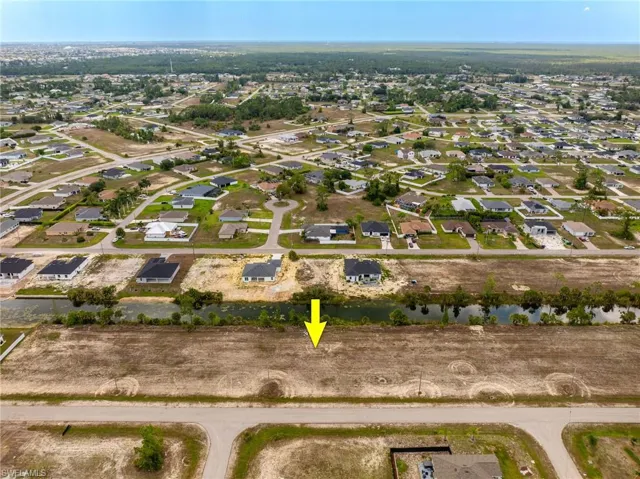 View of property location featuring a large body of water and nearby suburban area