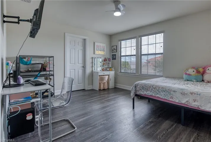 Bedroom featuring dark wood-type flooring and ceiling fan