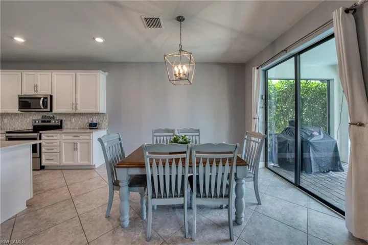 Tiled dining area featuring a chandelier