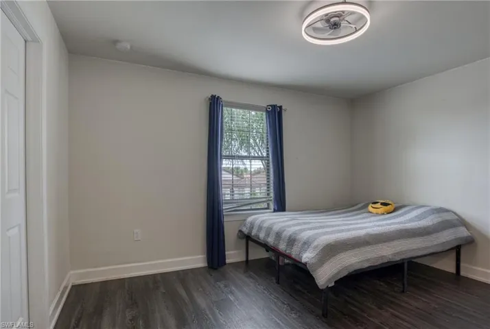 Bedroom featuring dark wood-type flooring