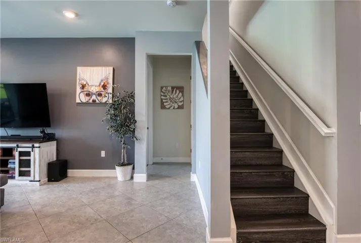 Stairs featuring tile patterned floors