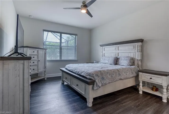 Bedroom featuring ceiling fan and dark hardwood / wood-style flooring