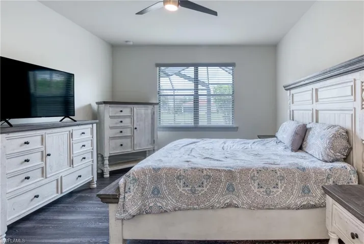 Bedroom with dark wood-type flooring and ceiling fan