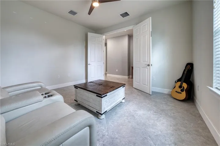 Living room featuring a healthy amount of sunlight and ceiling fan