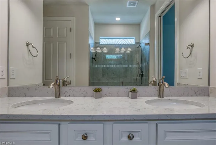 Bathroom featuring vanity and an enclosed shower