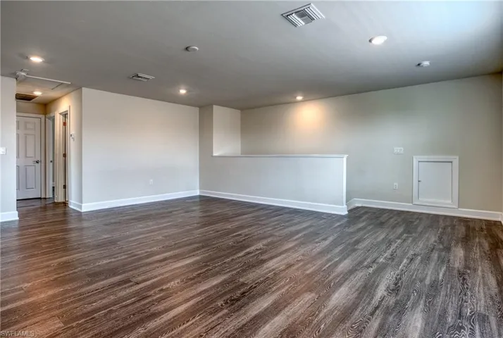 Unfurnished room with dark hardwood / wood-style flooring
