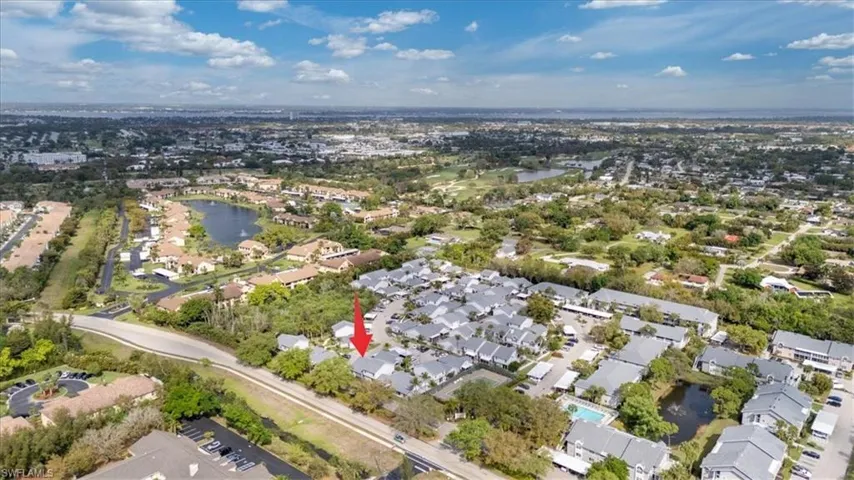 Aerial view of residential area featuring a large body of water