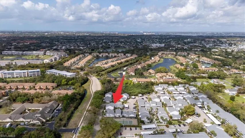 Aerial perspective of suburban area with a nearby body of water