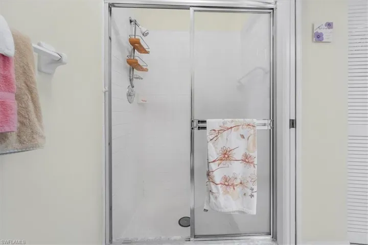 Full bathroom featuring a shower stall