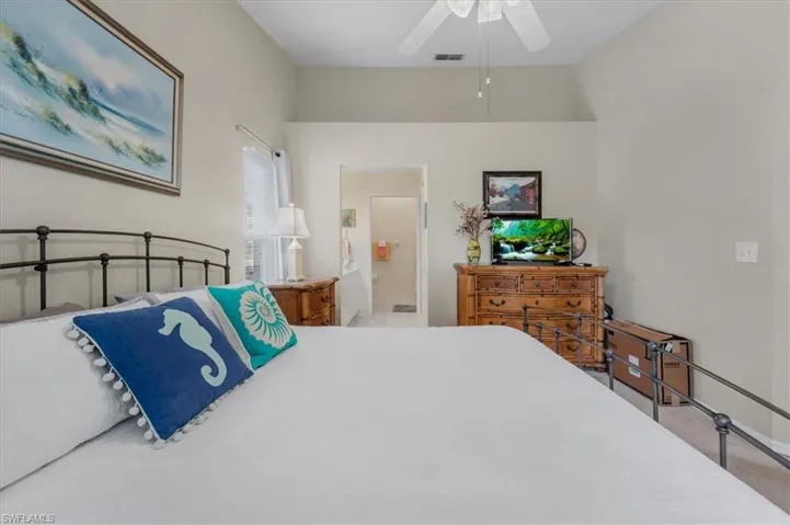 Bedroom with a ceiling fan and ensuite bathroom