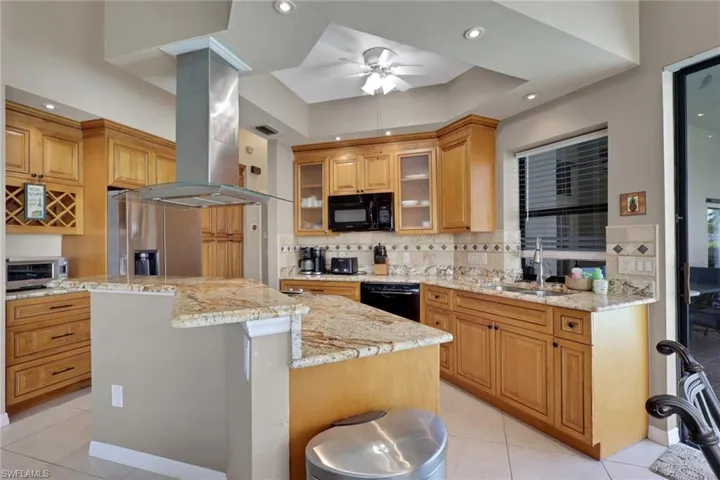Kitchen featuring honey-toned cabinetry, light-toned countertops, and a tile backsplash