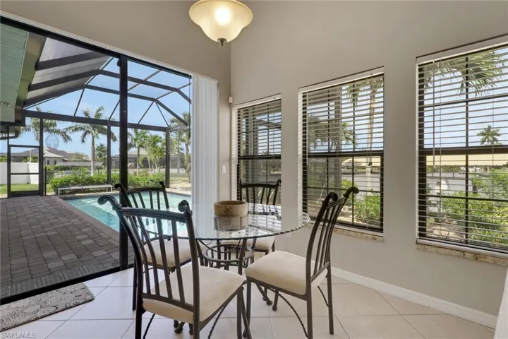 Interior dining space featuring tile flooring and a vaulted ceiling