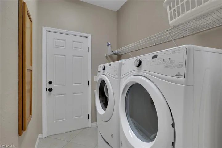 Dedicated laundry area featuring front-loading washer and dryer units