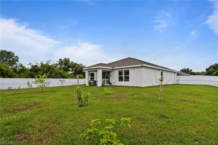 Rear view of property featuring stucco siding