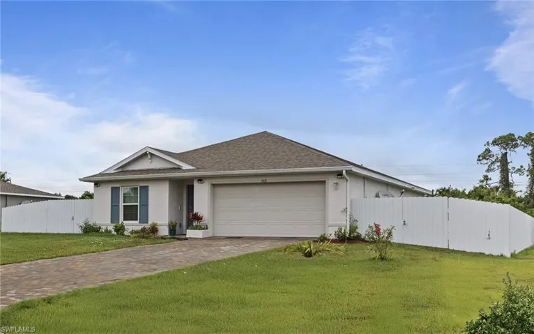 Single story home with a garage, driveway, stucco siding, and roof with shingles