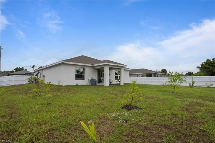 Back of property featuring stucco siding