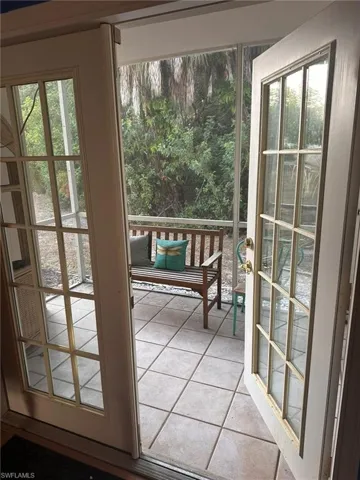 Doorway to outside featuring light tile patterned flooring