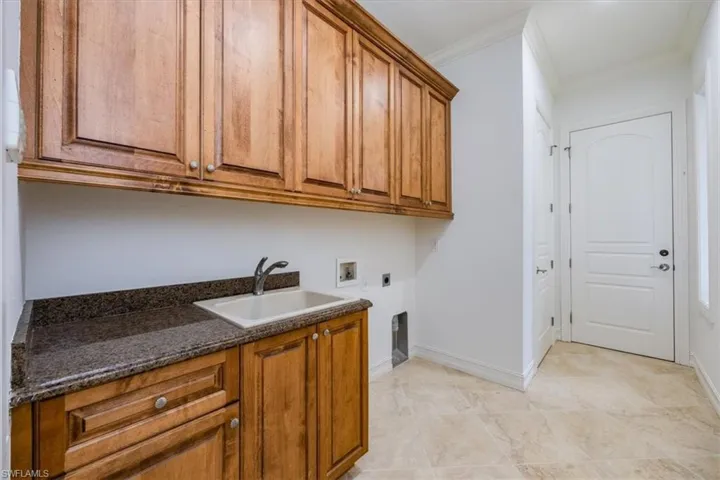 Laundry Room with built in wood cabinetry.