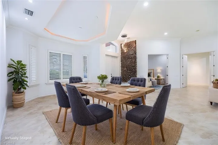 Virtually Staged - Dining area off the great room across from front entry and den.