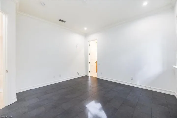 Guest bedroom with tile floors and access to the pool bath.