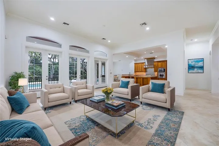 Virtually Staged - Great room with access to the kitchen and the pool/spa/lanai thru french doors.