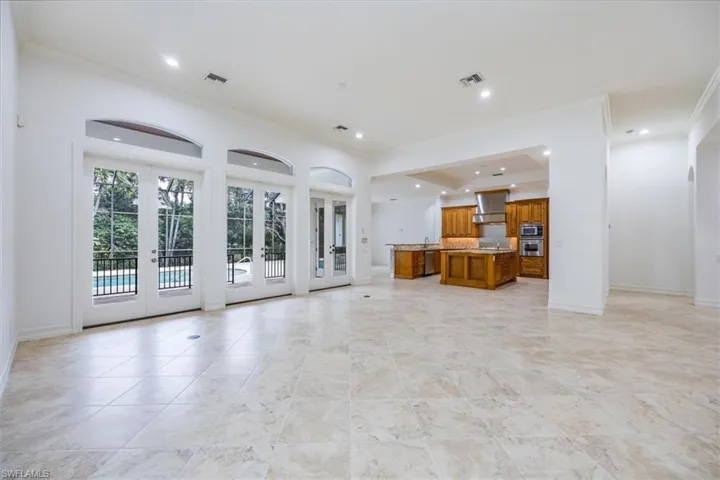 Great room with access to the kitchen and the pool/spa/lanai thru french doors.