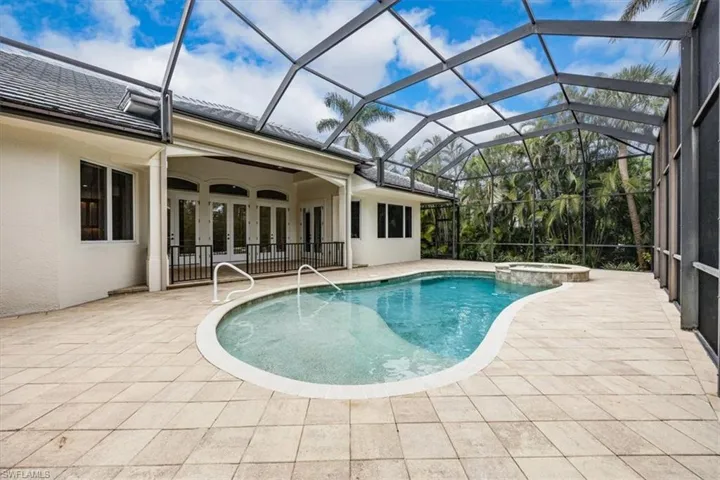 Enclosed lanai with pool, spa, covered area and outdoor kitchen (not shown).