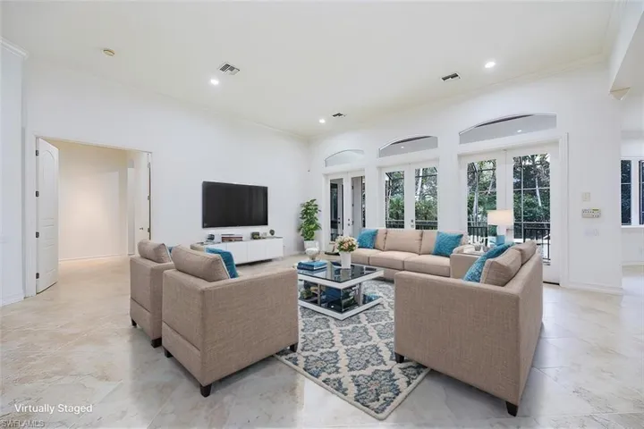 Virtually Staged - Great room with access to the kitchen and the pool/spa/lanai thru french doors.