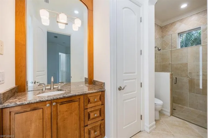 Pool bath with vanity, toilet and shower.