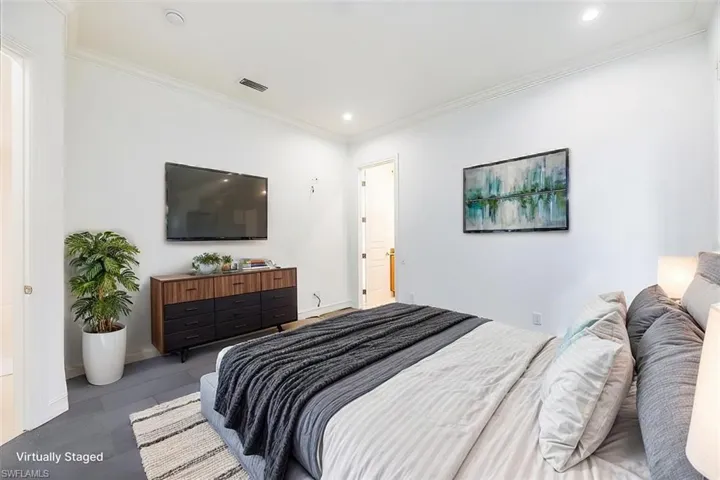 Virtually Staged - Guest bedroom with tile floors and access to the pool bath.