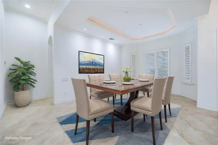 Virtually Staged - Dining room off the great room (not shown) across from the front door and the den.